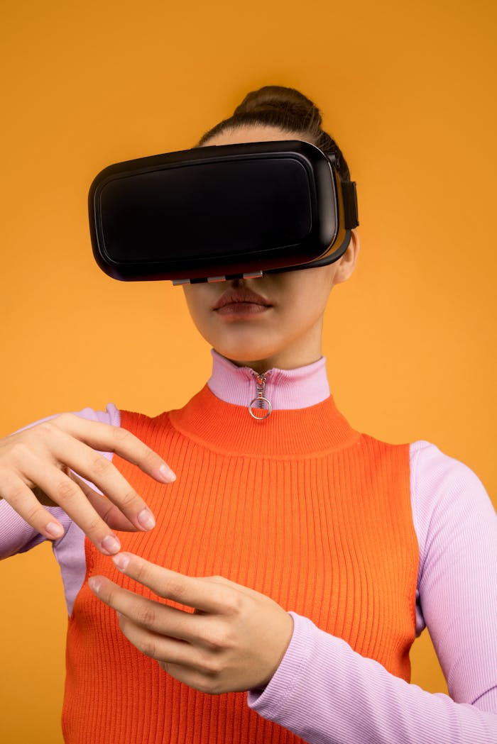 Woman immersed in virtual reality wearing VR headset, gesturing against orange background.